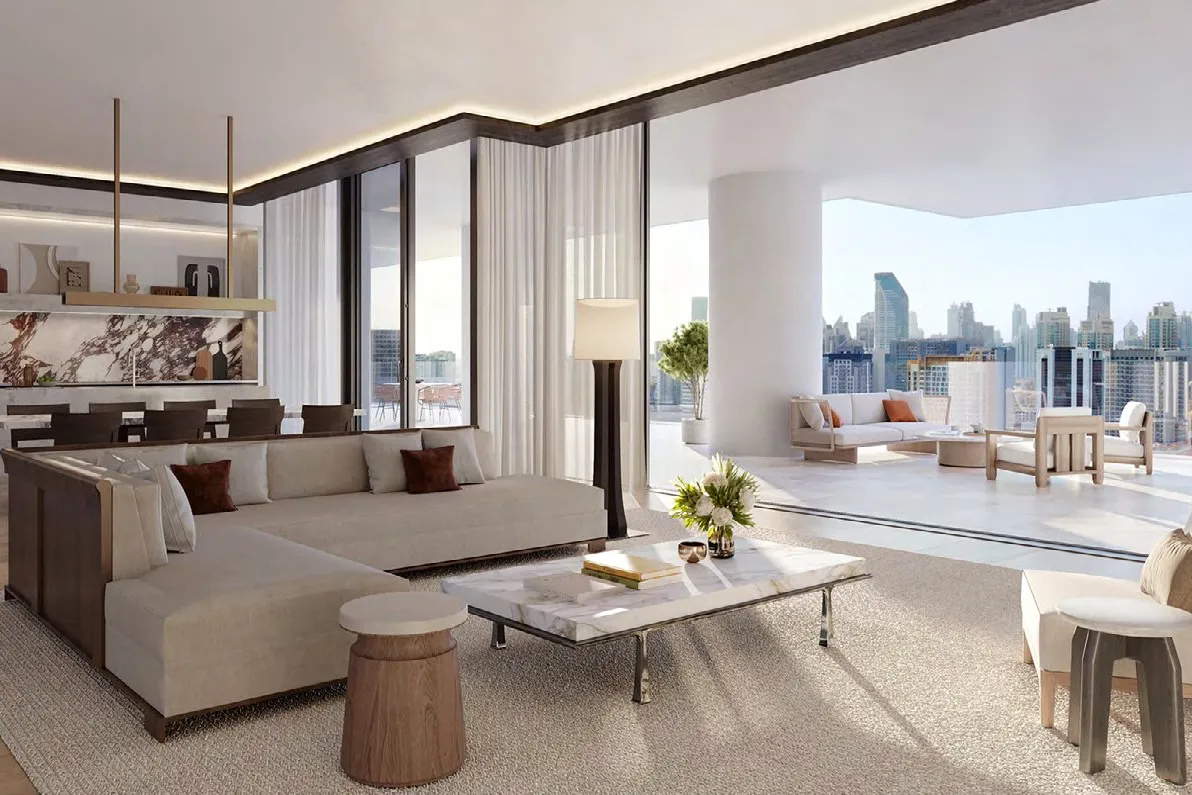 Bright living room opening onto a wide terrace above the city